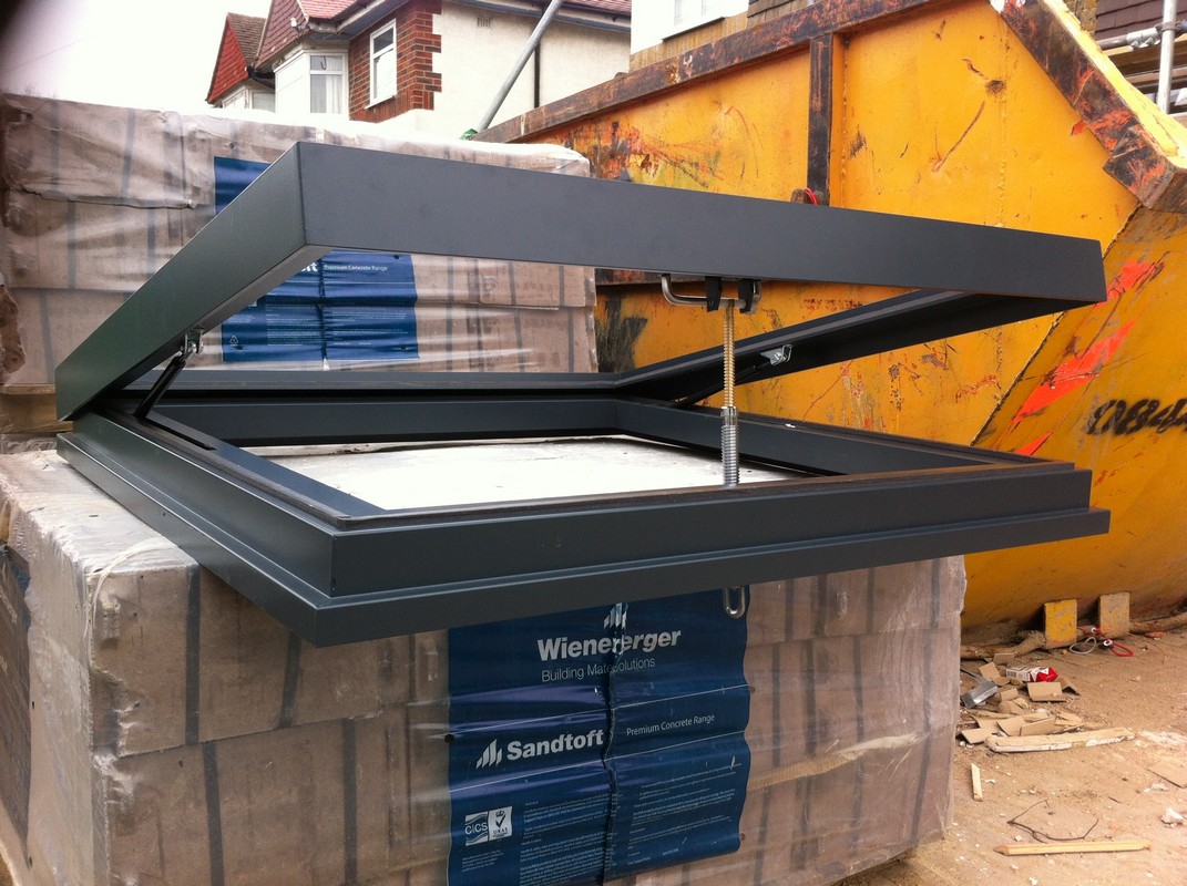 Opening flat roof skylight in anthracite grey installed in Plumstead